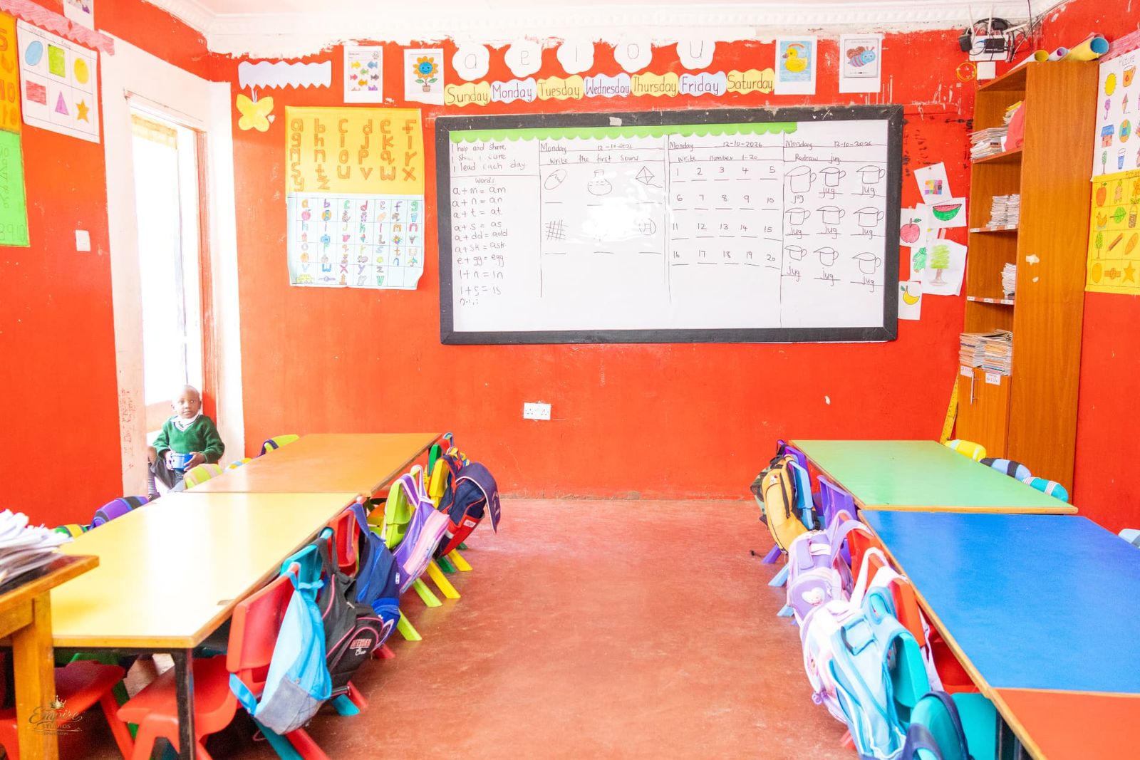 A bright pre-school classroom with the alphabet, number work and colourful tables