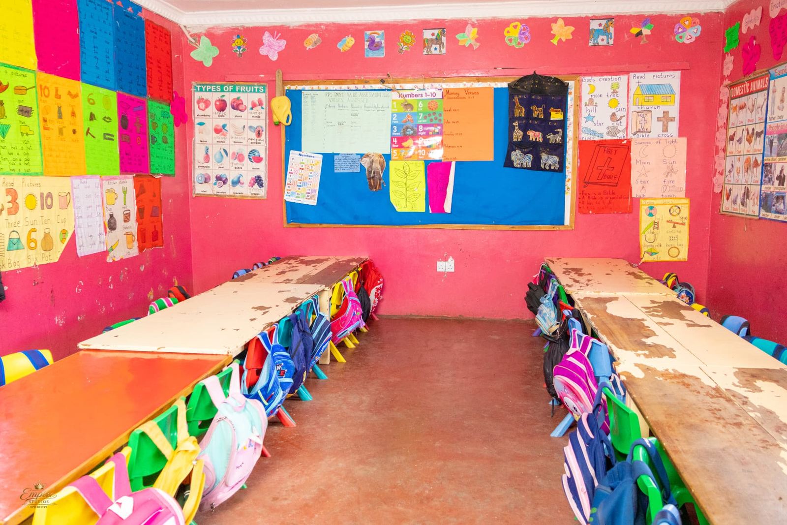 A bright PP1 classroom filled with learning charts, memory verses and pupils' artwork